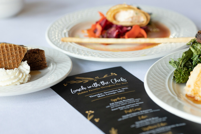 black paper menu surrounded by holiday favorite dishes