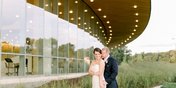 Bride and Groom standing and kissing one another