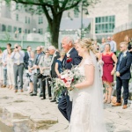 Bride walking with father down aisle 