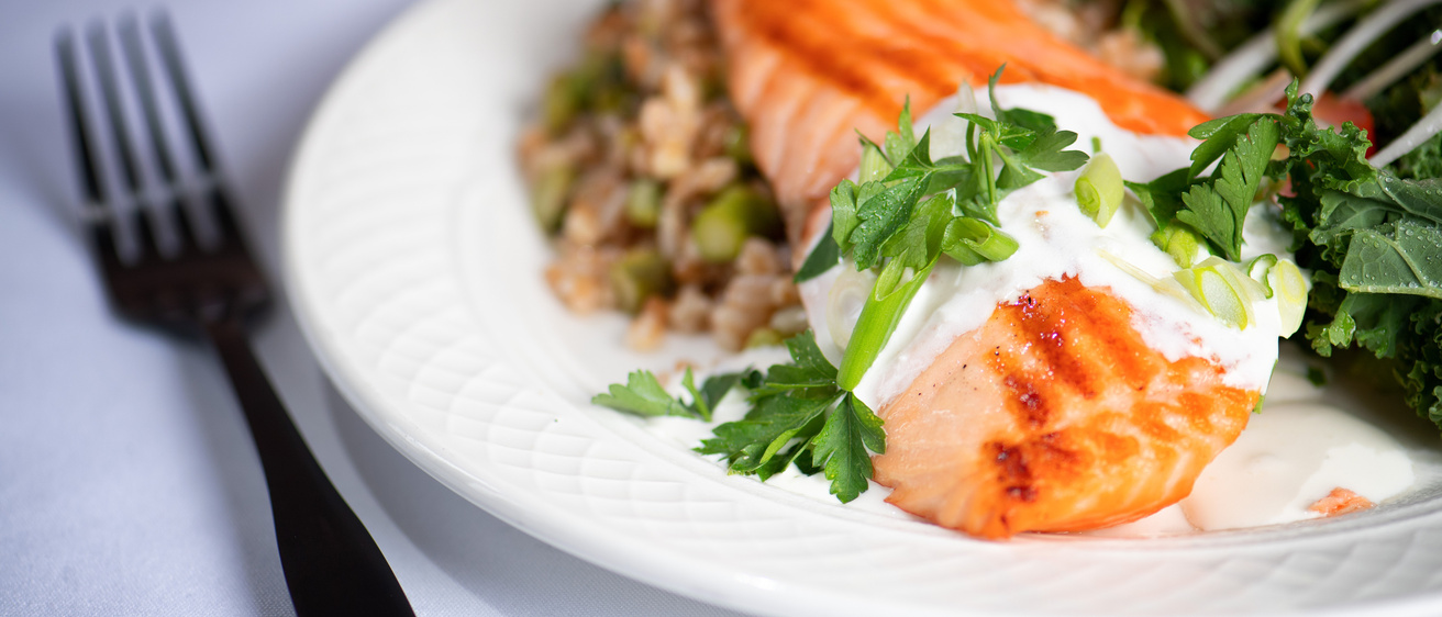 salmon and lettuce on a plate with fork